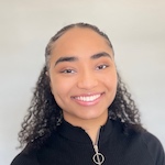 Headshot of a Black woman with a ponytail wearing a black zip-up.